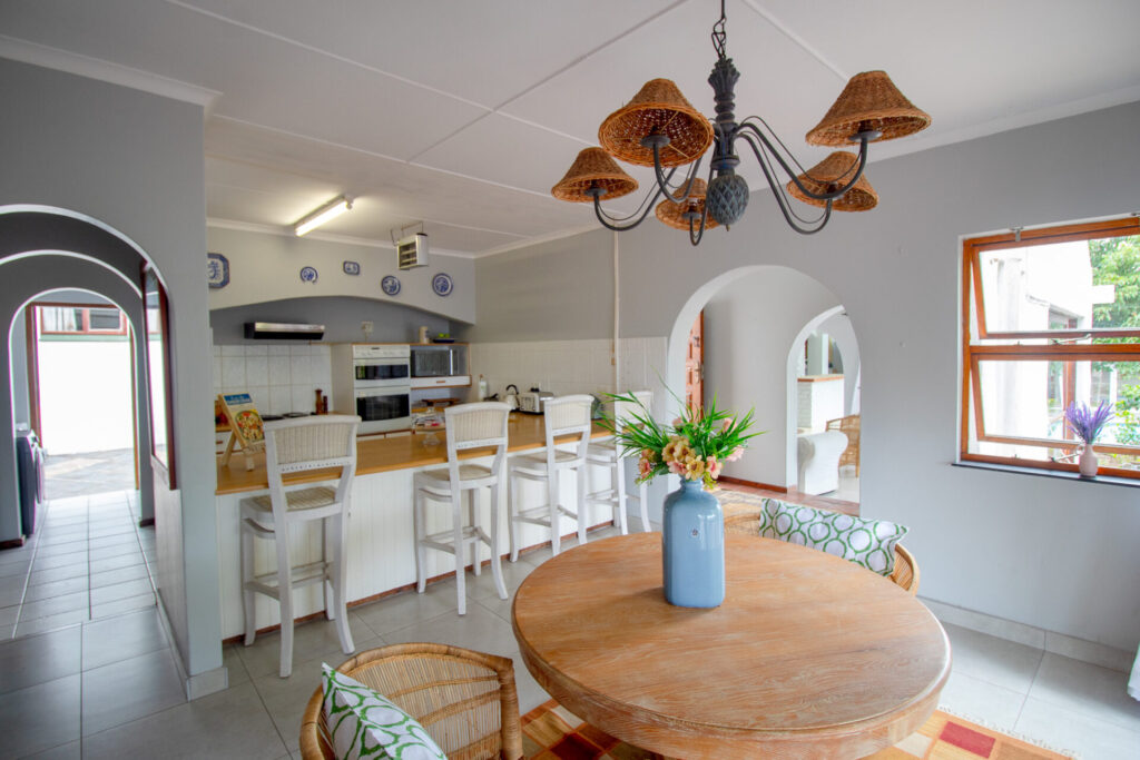 Open-plan kitchen and dining area with woven pendant lights