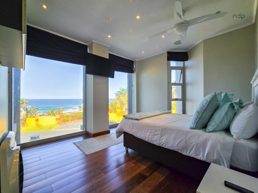 Bedroom with large windows overlooking the sea