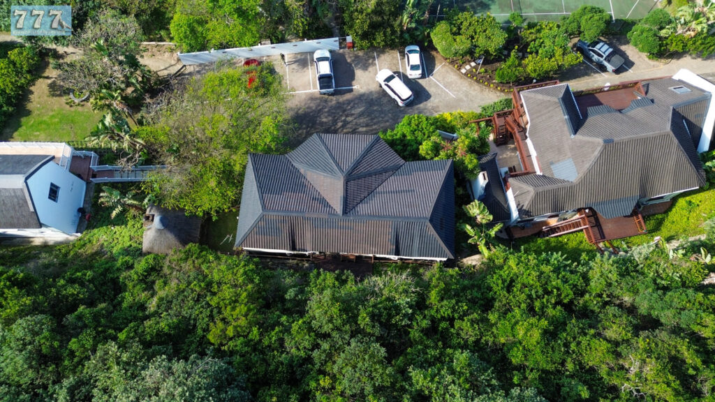 Aerial view of a home and neighbouring properties surrounded by trees
