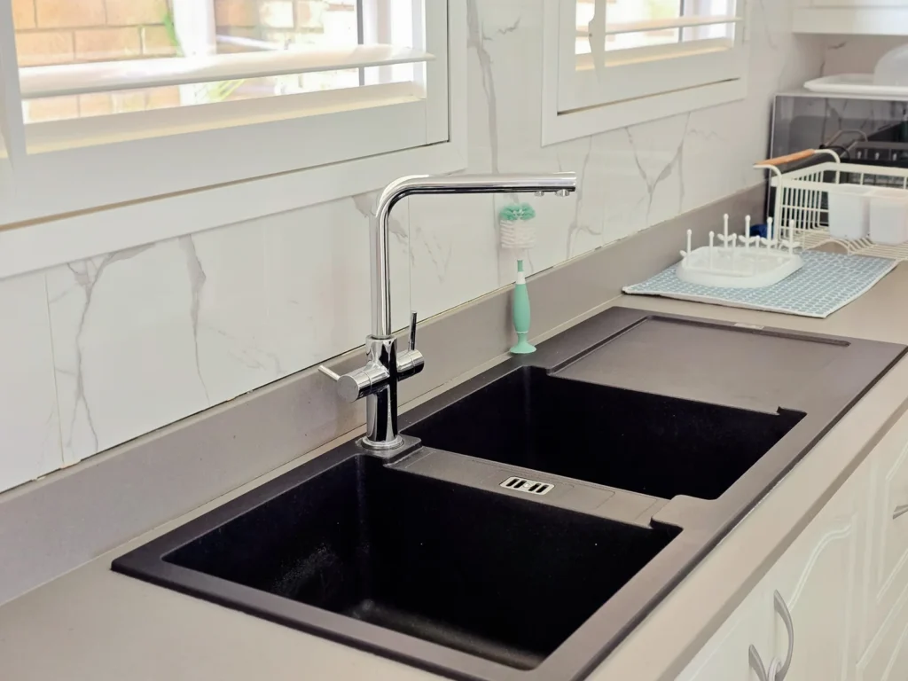 Kitchen detail with black double sink and chrome tap