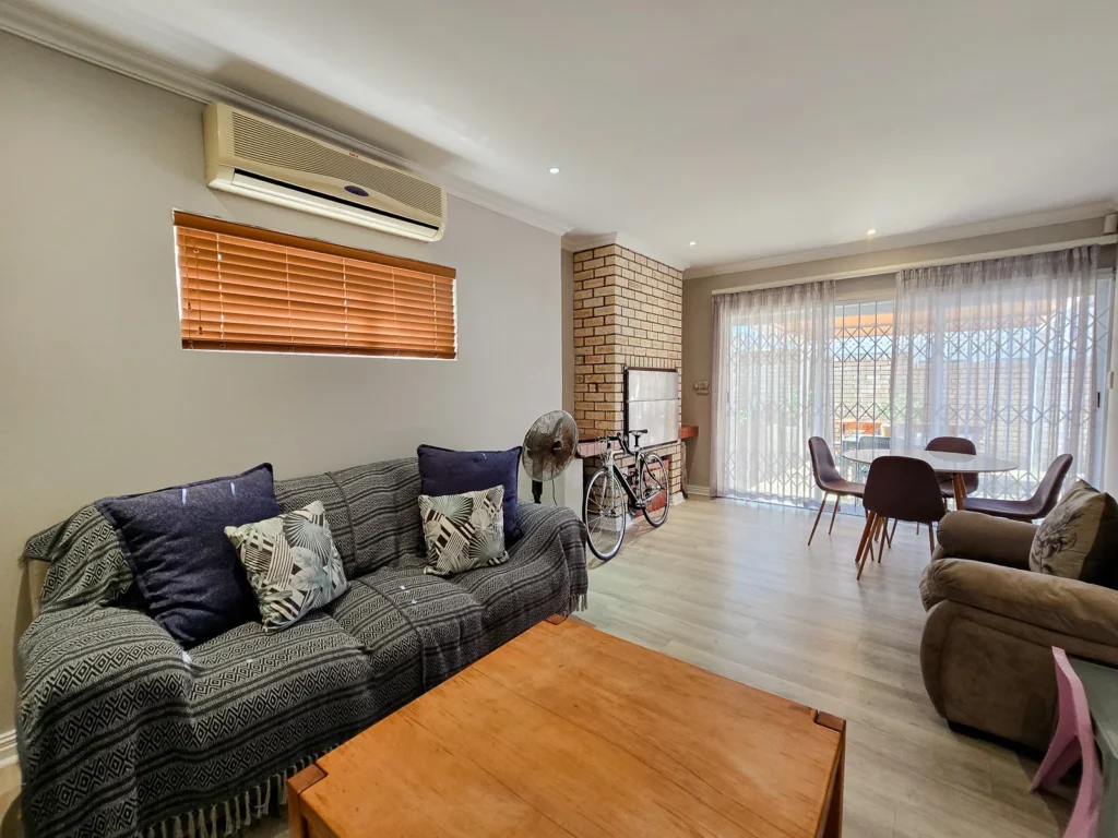 Lounge with timber flooring and dark seating