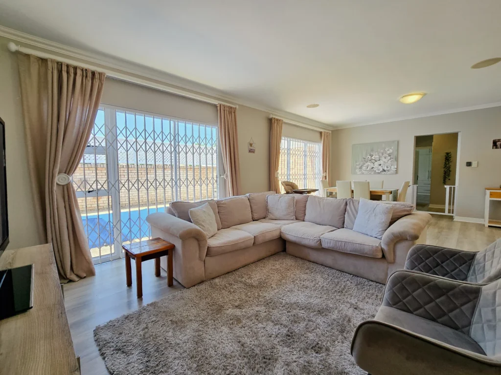 Light-filled lounge with cream seating and sliding glass doors