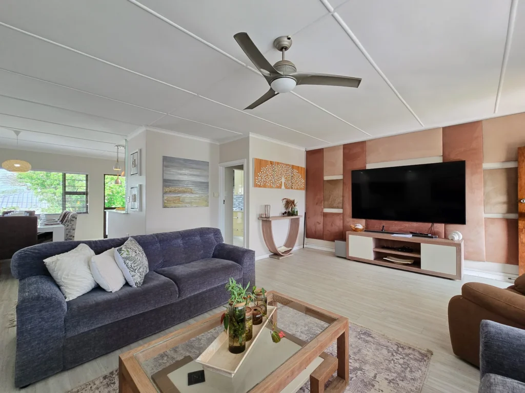 Living room with a wall-mounted television and garden views